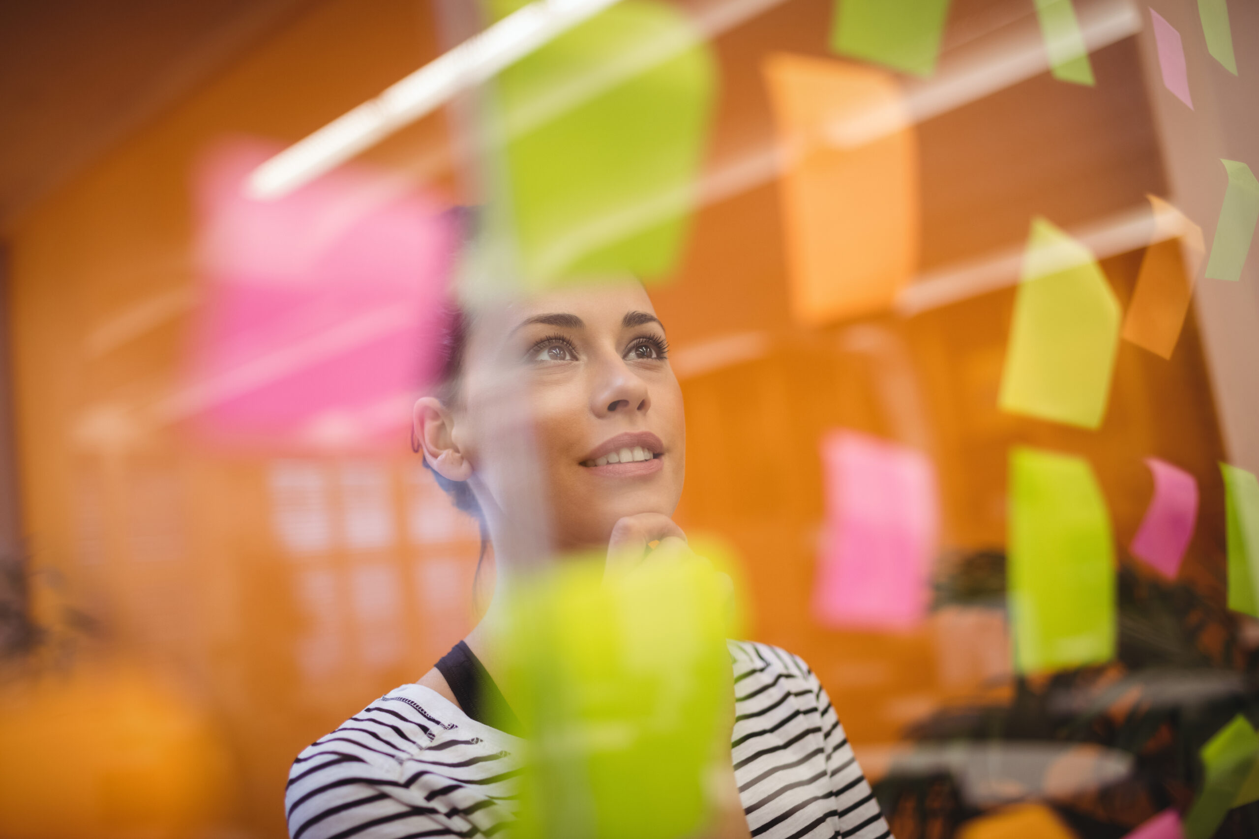 Female executive reading sticky notes